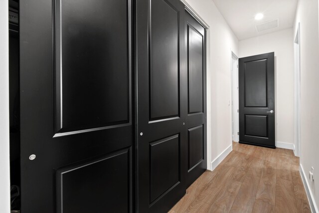 corridor featuring light hardwood / wood-style floors