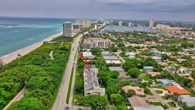 birds eye view of property featuring a beach view and a water view