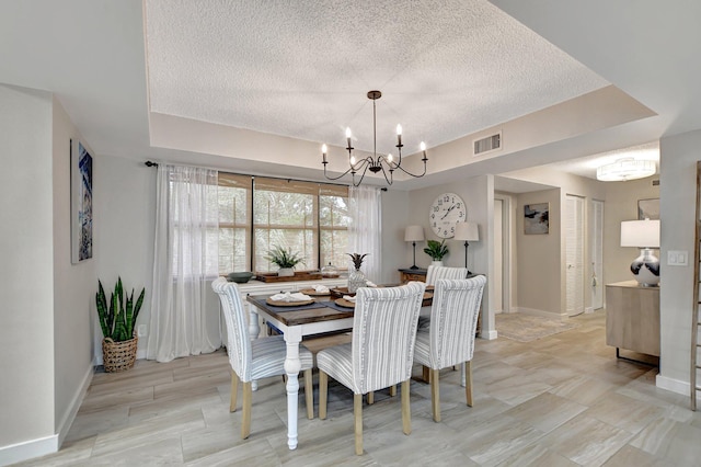 dining room featuring a textured ceiling and a notable chandelier