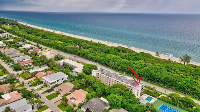 birds eye view of property featuring a water view and a beach view