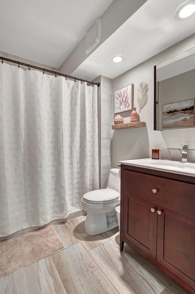 bathroom with vanity, toilet, and a shower with shower curtain