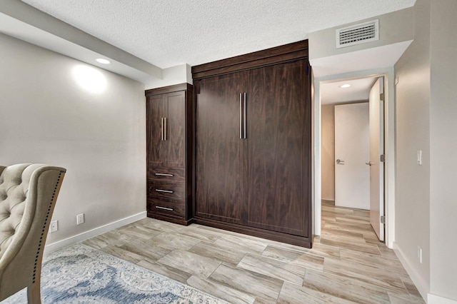 interior space with a textured ceiling