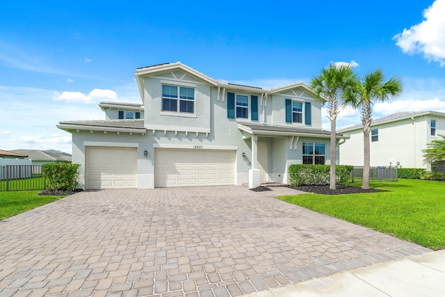 view of property featuring a front yard and a garage