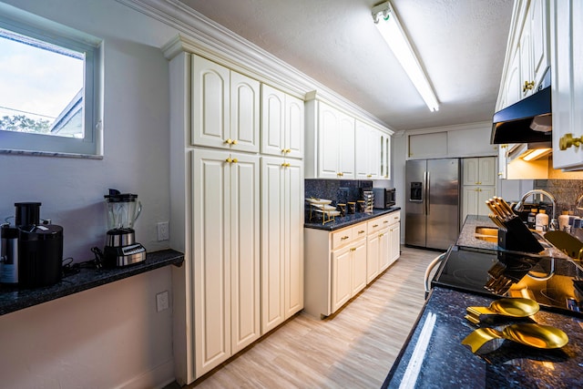 kitchen featuring sink, tasteful backsplash, light hardwood / wood-style flooring, stainless steel appliances, and range hood