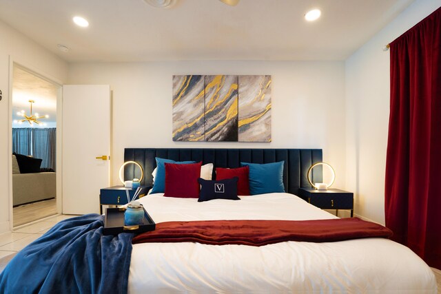 tiled bedroom with an inviting chandelier