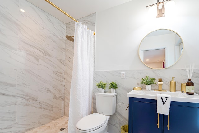 bathroom with vanity, toilet, curtained shower, and tile walls