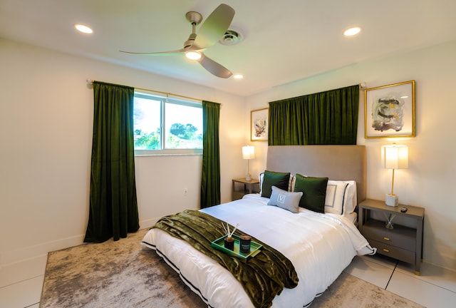 bedroom with ceiling fan and light tile patterned floors