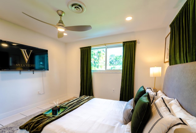 tiled bedroom featuring ceiling fan