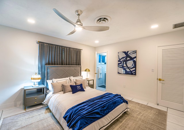 tiled bedroom featuring ceiling fan and ensuite bathroom