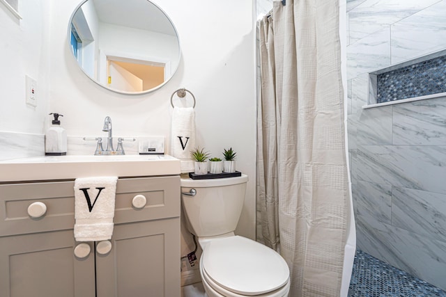 bathroom featuring vanity, toilet, and a shower with shower curtain