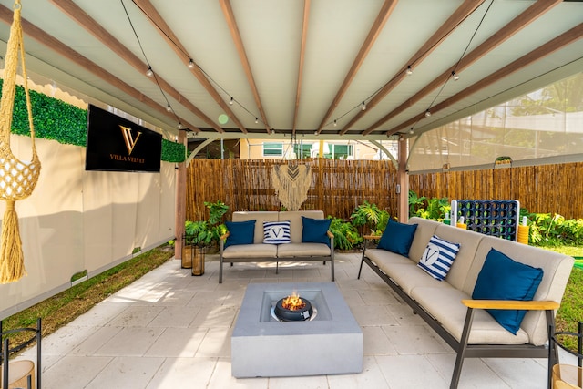 view of patio / terrace with an outdoor living space with a fire pit