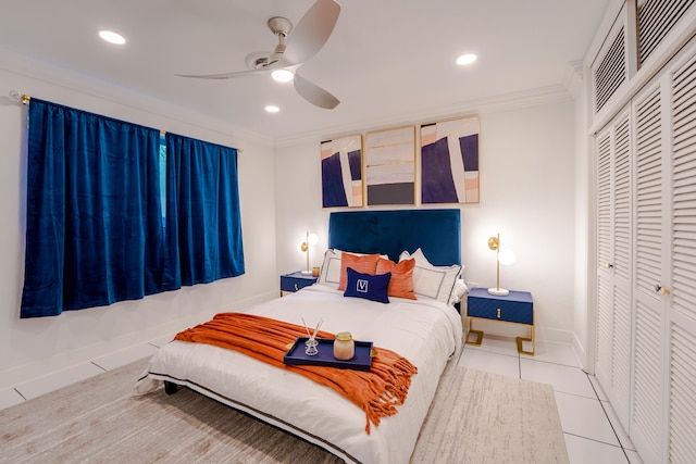 tiled bedroom featuring ceiling fan, crown molding, and a closet