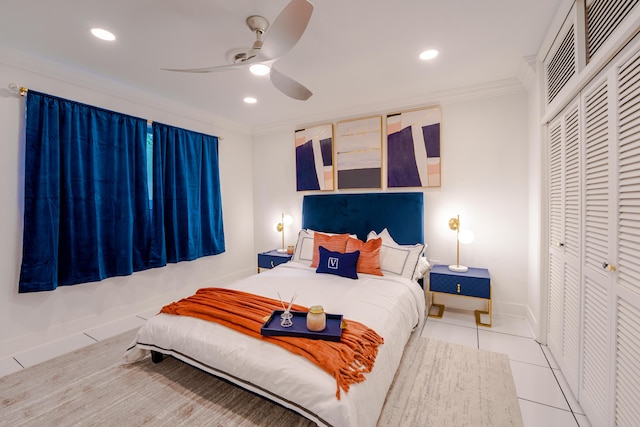 bedroom with light tile patterned floors, crown molding, a closet, and ceiling fan