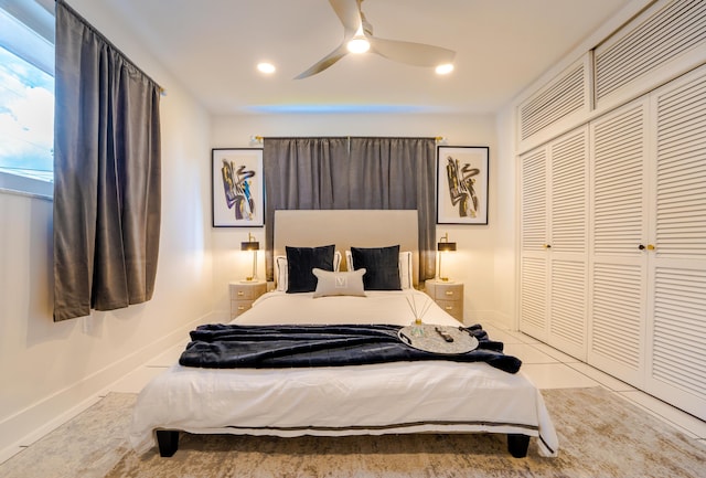 bedroom with light tile patterned floors, ceiling fan, and a closet