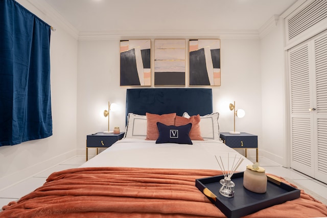 bedroom featuring tile patterned flooring, a closet, and ornamental molding