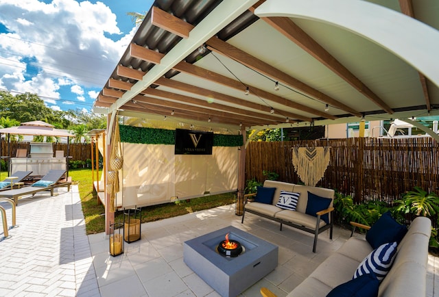 view of patio / terrace featuring area for grilling and an outdoor living space with a fire pit