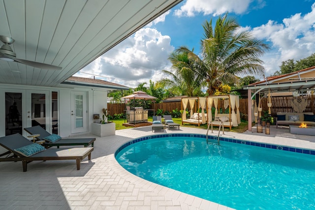 view of swimming pool featuring a patio, french doors, and ceiling fan