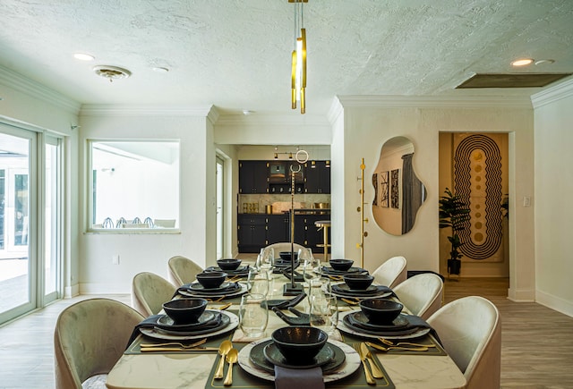 dining room with plenty of natural light, crown molding, and hardwood / wood-style flooring