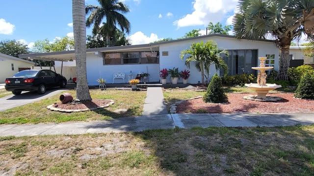 view of front of property featuring a carport