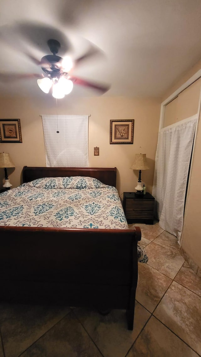 tiled bedroom with ceiling fan