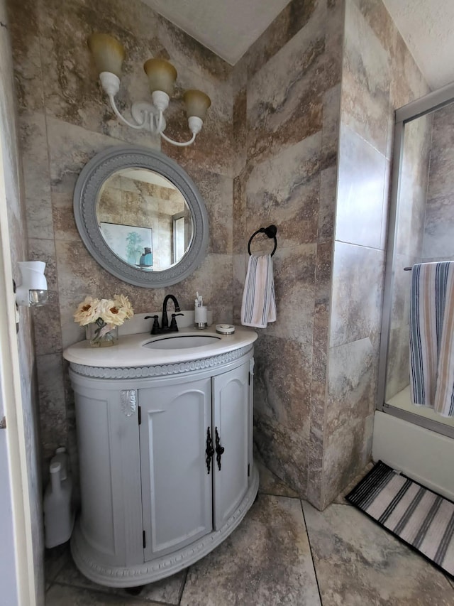 bathroom featuring  shower combination, tile walls, vanity, and tile patterned flooring