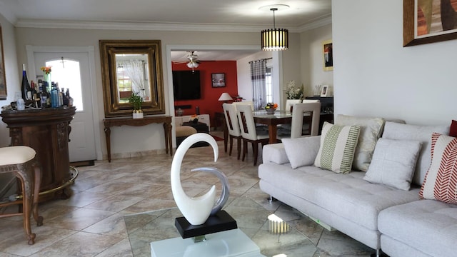 living room featuring light tile patterned flooring, ceiling fan with notable chandelier, and ornamental molding