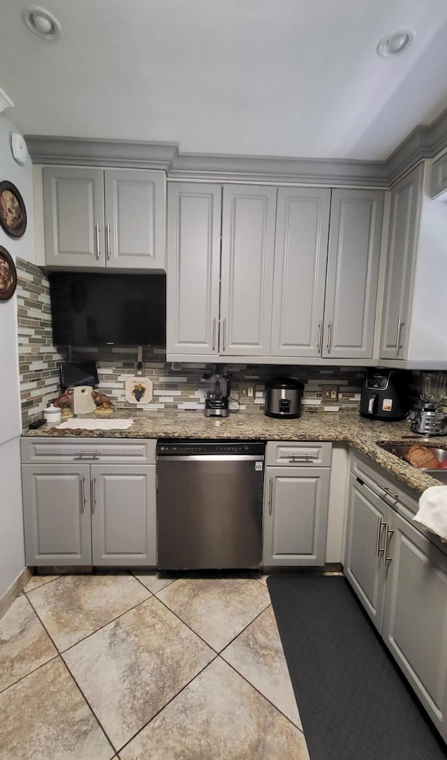 kitchen featuring gray cabinetry, decorative backsplash, stainless steel dishwasher, and light tile patterned floors