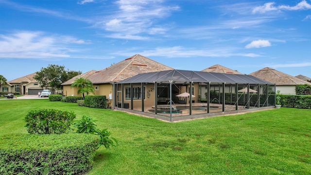 back of property featuring a lanai, a lawn, a swimming pool, and a patio