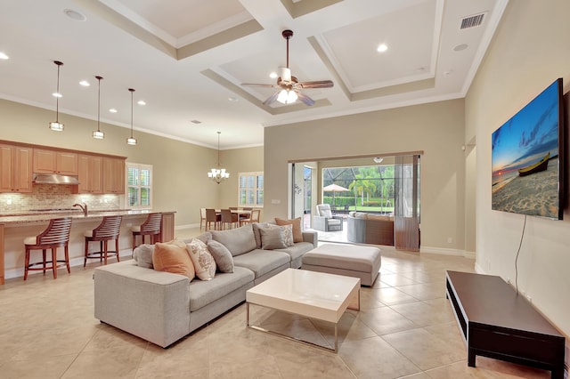 living room featuring coffered ceiling, light tile patterned floors, plenty of natural light, and ornamental molding