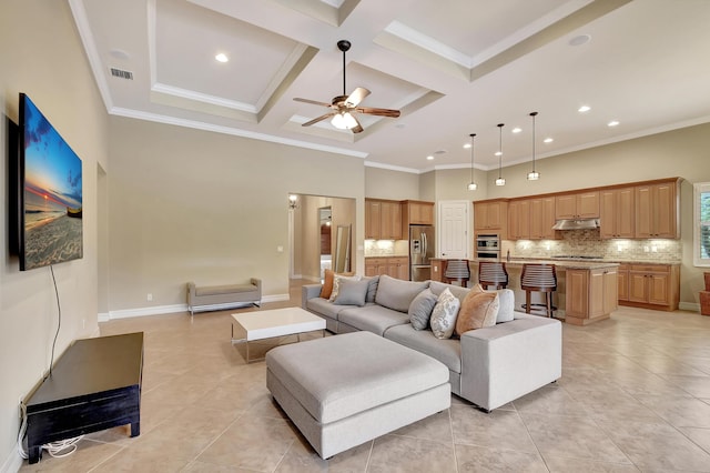 living room with coffered ceiling, light tile patterned floors, crown molding, and a high ceiling