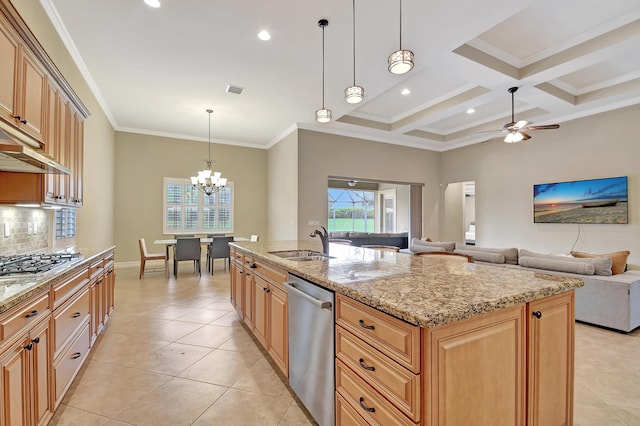 kitchen featuring pendant lighting, sink, appliances with stainless steel finishes, a kitchen island with sink, and light stone counters