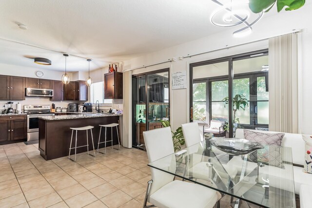 tiled living room featuring ceiling fan and a towering ceiling