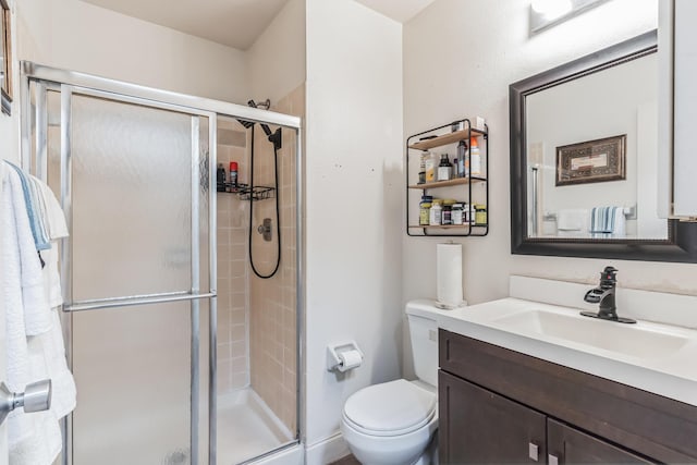 bathroom featuring vanity, toilet, and walk in shower