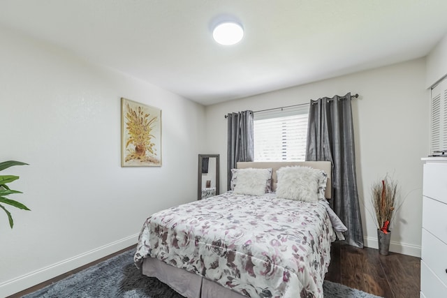 bedroom with dark hardwood / wood-style floors