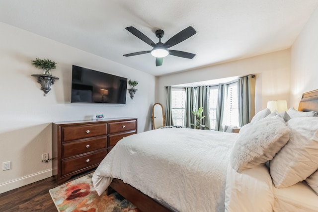 bedroom with ceiling fan and dark hardwood / wood-style flooring