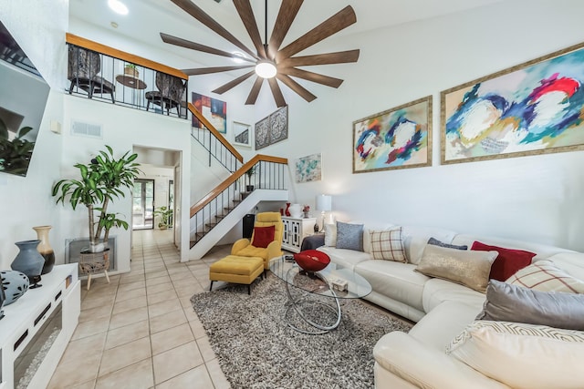 living room with a high ceiling and light tile patterned floors