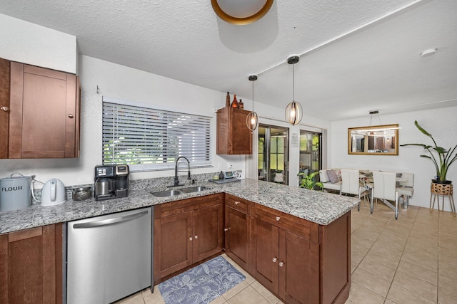 kitchen with decorative light fixtures, dishwasher, sink, kitchen peninsula, and light stone countertops