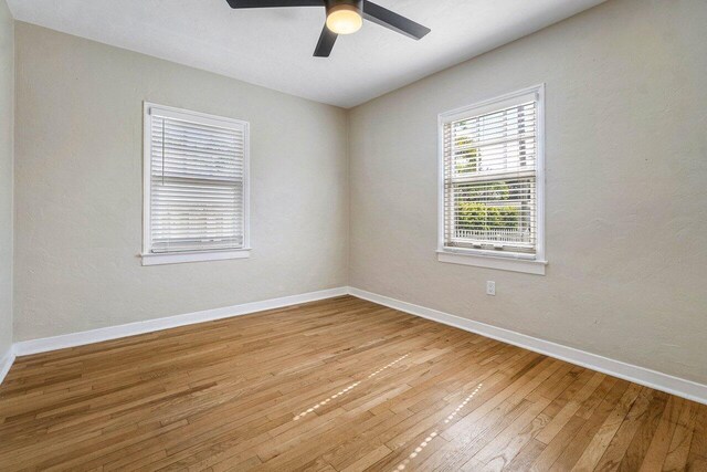 spare room featuring ceiling fan and hardwood / wood-style flooring