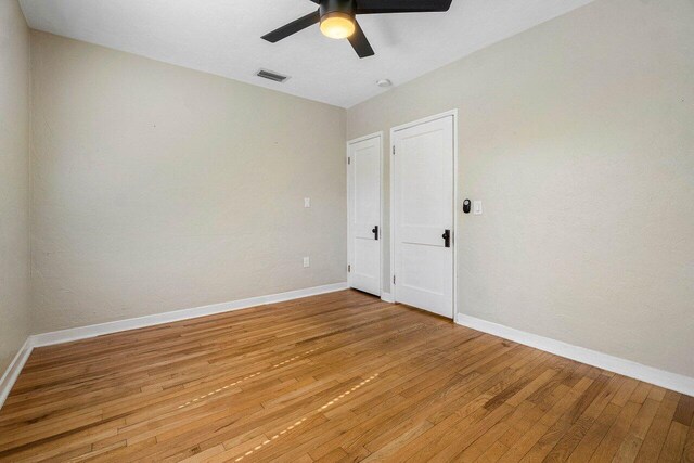 spare room featuring ceiling fan and light hardwood / wood-style floors