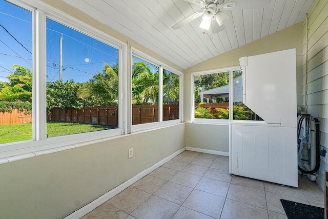 unfurnished sunroom featuring lofted ceiling, ceiling fan, and a healthy amount of sunlight