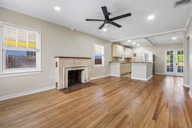 unfurnished living room featuring plenty of natural light and hardwood / wood-style floors