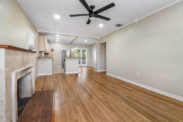 unfurnished living room featuring ornamental molding, light tile patterned floors, a high end fireplace, and ceiling fan