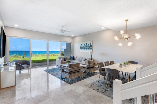 living room with a textured ceiling and ceiling fan with notable chandelier