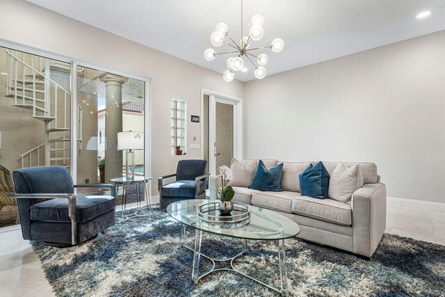 tiled living room with a chandelier and a textured ceiling