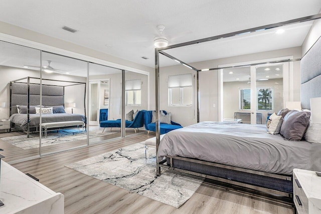 bedroom with wood-type flooring, a closet, and ceiling fan