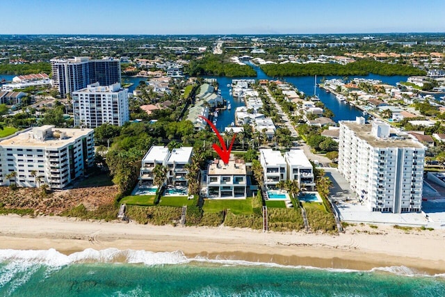 birds eye view of property with a water view and a view of the beach