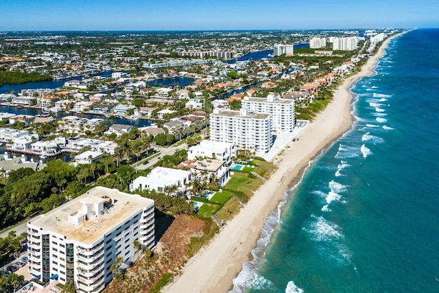 drone / aerial view with a beach view and a water view