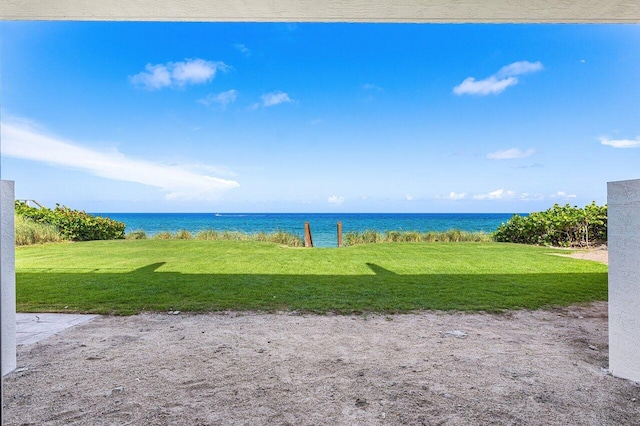 exterior space with a water view and a lawn