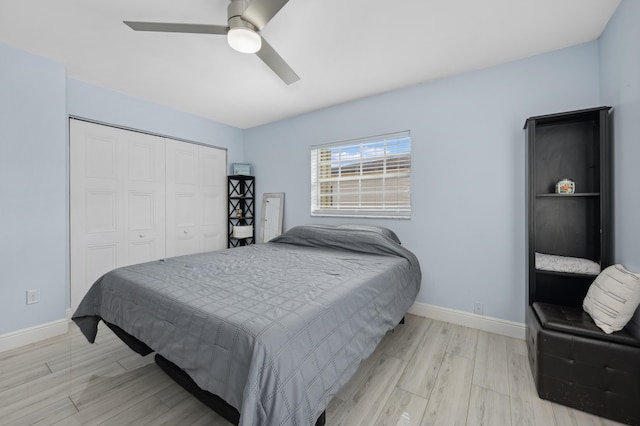 bedroom featuring a closet, light hardwood / wood-style flooring, and ceiling fan