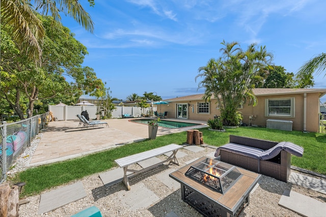 view of patio / terrace featuring a fenced in pool and an outdoor fire pit